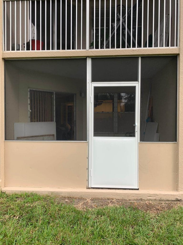Ground-level patio with tools and screen enclosure being renovated.